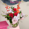 A brilliant arrangement featuring 6 red roses, 6 pink roses, Glaminis, Stock