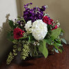 All around arrangement with royal colors of love in a cylindrical glass