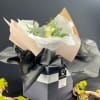 Hand tied bouquet designed in a square black matte box in a