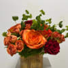 mixed flowers in gold translucent vase