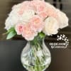 A beautiful blush bouquet with multicolored blush carnations, peach carnations, white hydrangeas