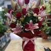 This beautiful arrangement of pink lilies and red roses is a perfect