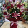 This beautiful arrangement of pink lilies and red roses is a perfect