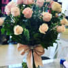 Arrangement includes two dozen lovely pink roses with a stylish bow. 