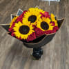 Beautiful bouquet of roses and sunflowers to fall in love or apologize