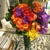 Orange circus roses, tulips, purple vanda orchids and yellow calla lillies. 