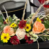 The centerpiece is composed of soft peach and cream roses, symbols of