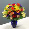 Brilliant orange roses, yellow alstroemeria, red carnations and miniature carnations, yellow daisy