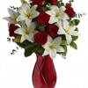 A beautiful arrangement of white Lilies and red Roses with mixed greenery.
*Vases