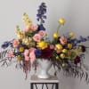 Heat things up with happy, sping pink roses and yellow ranunculus, blue