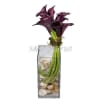 Purple calla lilies, cymbidium heads, river rocks with decorative green moss in