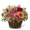 A beautiful arrangement of pink Lilies, pink Carnations, hot pink Roses, peach