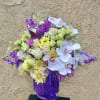 Beautiful purple, green, and white arrangements with roses, stock, orchids, chrysanthemums, and