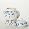 This ginger jar features blue floral artwork on a stylish ceramic jar.