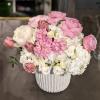 Textured white ceramic bowl filled with spring favorites such as tulips, garden