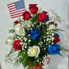 A patriotic array of a dozen roses. Accented with babies breath, an