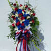 A full and fresh standing spray filled with assorted red, white, and