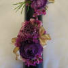 Boutonniere and Wrist corsage on a pearl bracelet.  Contains purple ranunculus