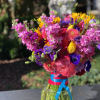 This boldly colorful and bright bouquet is bursting with full and lush