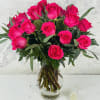 A stunning arrangement of 18 long-stemmed, vibrant hot pink roses, exuding passion