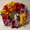 Beautiful bright colors of yellow, orange, burgundy and purple with roses, gerbera