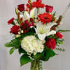 Traditional vase arrangement of mixed flowers of Red Roses, Hydrangea, Lily, Gladiolus