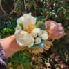 This beautiful Corsage in white and gold features white roses and spray