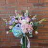 Pastel hydrangeas, roses, tulips, stock, anemones, pink larkspur, dusty Miller and Eucalyptus