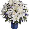 Beautiful blooms such as cr&egrave;me roses, white lilies and alstroemeria along with