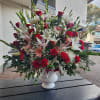 A floor basket arrangement mixed with roses, glads, carnations snapdragons. stargazer, mums