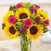 sunflowers and pink roses on a clear vase