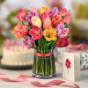 Stunning paper floral bouquet pops open and brings color to any room.