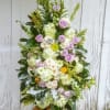 Beautiful display of roses, hydrangeas and seasonal flowers presented on an easel.