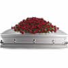 Red roses are arranged with rich green salal into a classic casket
