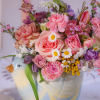 A sweet mother hen carries a Spring filled floral arrangement delight.
Brighten your