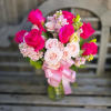 This arrangement features hot pink roses and light pink supporting florals including