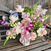 This arrangement features premium multicolor Hydrangea from Holland, Cymbidium Orchid, Dendrobium Orchid