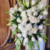 Classic all white standing funeral spray. Featuring white roses, white lily, white