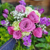 An array of violet colored florals such as purple roses, tulips, stock