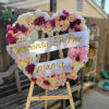 This Open Heart Standing Funeral Spray is made with Daisy in white
