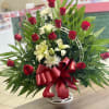 A beautiful standing basket arranged with red roses and white lilies in