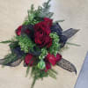 Deep Red roses, black ribbon and white accents give this corsage and
