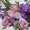 This arrangement boasts a striking spectrum of purple, from lavender to deep