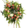 Mix of orange roses, orchids, protea, alstromeria, snapdragon and tropical leaves