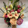 This lavish peach arrangement is composed of peach gerbera daisies, both lavender