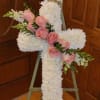 This Cross is designed in white with a pink rose sash.