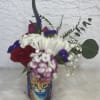 Cans full of love decorated with fresh seasonal flowers.