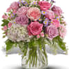These beautiful pink and lavender roses seem to have a light of