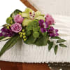 This exquisite arrangement of floral favorites featuring a green cymbidium orchid placed