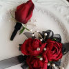 A classic red rose and baby&#039;s breath corsage compliments any outfit. Perfect